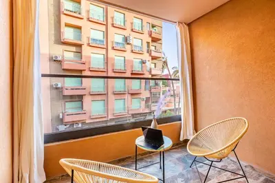 a laptop sitting on a chair in front of a window at Luxury 1BR in gueliz in Marrakech
