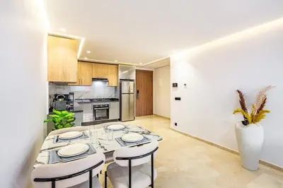 a dining room with a table and chairs in a kitchen at Luxury 1BR in gueliz in Marrakech