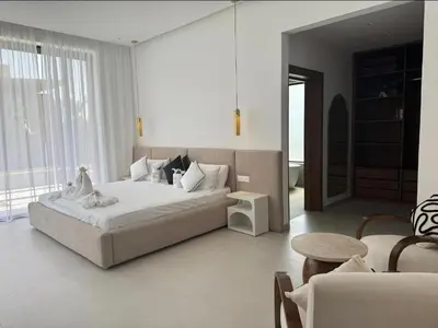 a bedroom with a bed and a table and a couch at Beautiful Villa K&L in Marrakech