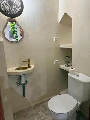 a bathroom with a toilet and a sink at Amber in Marrakech
