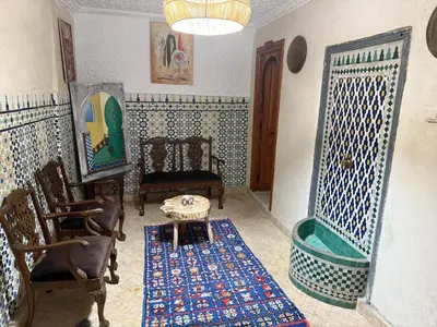 a living room with chairs and a table in a room at Amber in Marrakech