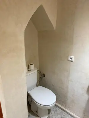 a bathroom with a white toilet in a room at Amber in Marrakech
