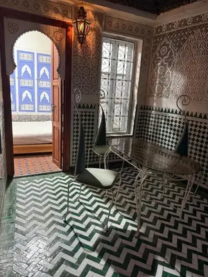 a room with a table and chairs and a window at Amber in Marrakech