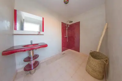 a bathroom with a red sink and a shower at Riad Dahab in Marrakech
