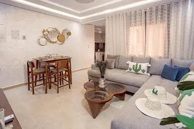 a living room with a couch and a table at Appartement confortable au cœur de Gueliz in Marrakech