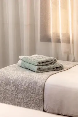 two stacks of towels sitting on top of a bed at Appartement confortable au cœur de Gueliz in Marrakech