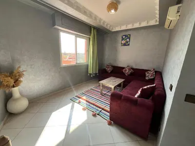 a living room with a couch and a table at Appart hotel ali in Marrakech