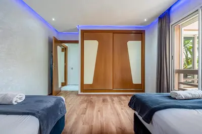a room with two beds and a large mirror at Atlas view apartment in Marrakech