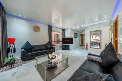 a living room with a couch and a table at Atlas view apartment in Marrakech