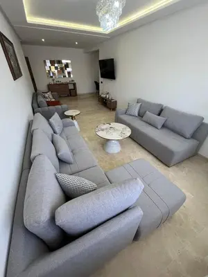 a living room with a couch and a table at Appartement prestige gueliz in Marrakech