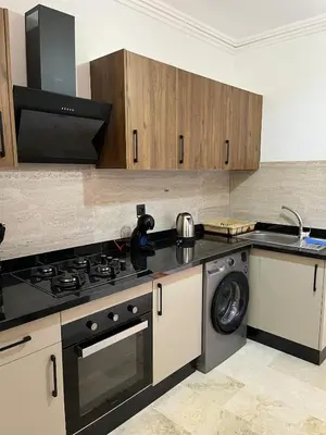 a kitchen with a stove and a washing machine at Appartement prestige gueliz in Marrakech