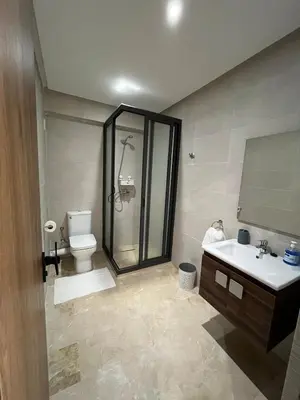 a bathroom with a shower and a toilet and a sink at Appartement prestige gueliz in Marrakech