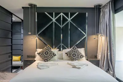 a bedroom with a large white bed with two pillows at Villa Illao 2 Pool, Jacuzzi & Cinéma in Marrakech