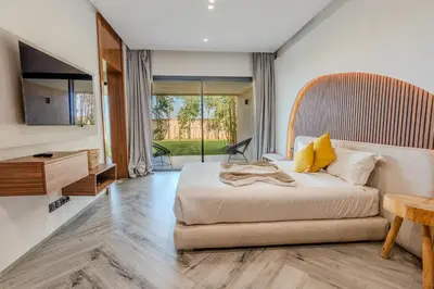a bedroom with a large bed and a table at Villa Illao 2 Pool, Jacuzzi & Cinéma in Marrakech