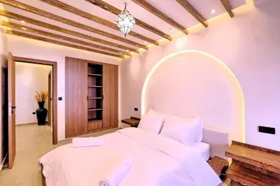 a bedroom with a large white bed with a large mirror at Chic & Comfort, Experience Marrakech differently in Marrakech