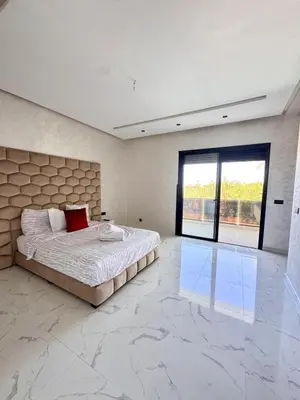 a bedroom with a bed and a large marble floor at Villa Prestige Zakarya - GOLF AKENZA2 MARRAKECH in Marrakech