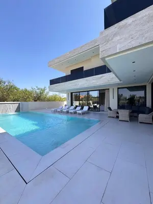 a swimming pool in the backyard of a house at Villa Prestige Zakarya - GOLF AKENZA2 MARRAKECH in Marrakech