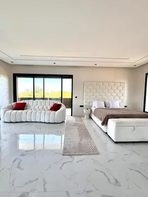 a bedroom with two beds and a large bed and a couch at Villa Prestige Zakarya - GOLF AKENZA2 MARRAKECH in Marrakech