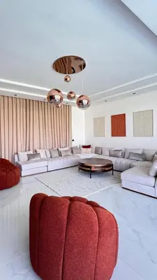 a living room with a red couch and a table at Villa Prestige Zakarya - GOLF AKENZA2 MARRAKECH in Marrakech