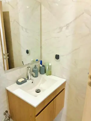 a bathroom with a sink and a mirror at Appartement 2 chambres à Marrakech - Résidence Soulaymane, in Marrakech