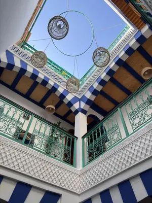a building with a balcony with a glass ceiling at Riad Zahri 18 in Marrakech