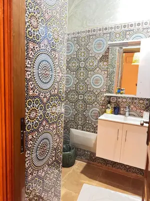 a bathroom with a sink and a mirror at Riad Zahri 18 in Marrakech