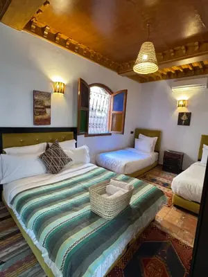 a bedroom with two beds in a room at Riad Zahri 18 in Marrakech
