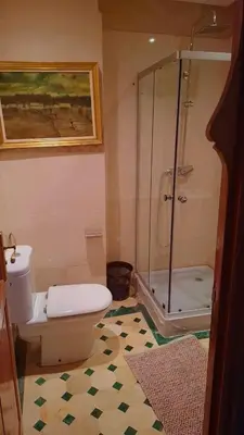 a bathroom with a toilet and a glass shower at Appartement Majorella Gueliz in Marrakech