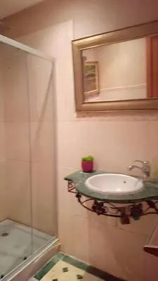 a bathroom with a sink and a glass shower at Appartement Majorella Gueliz in Marrakech