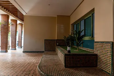 a hallway of a building with a potted plant at studio au centre ville marrakech calme et confort in Marrakech