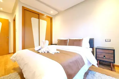a bedroom with a large bed with white sheets at Exceptional stay in Marrakech, Comfort & Style in Marrakech