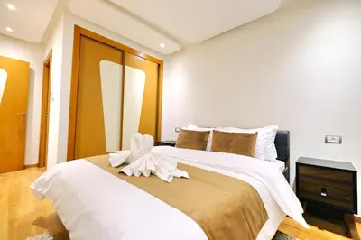 a bedroom with a large bed with a white flower on it at Exceptional stay in Marrakech, Comfort & Style in Marrakech