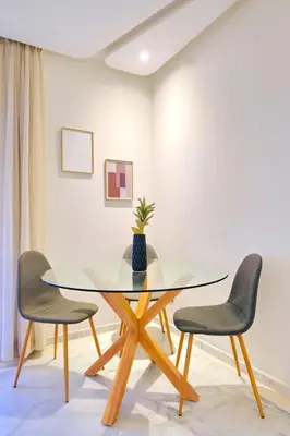 a dining room with a glass table and two chairs at Exceptional stay in Marrakech, Comfort & Style in Marrakech