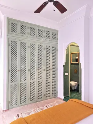 a bedroom with a large closet with a mirror at Riad 29 Mouassine in Marrakech