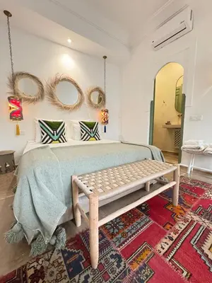a bedroom with a bed with mirrors on the wall at Riad 29 Mouassine in Marrakech