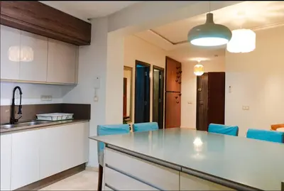 a kitchen with a table and blue chairs at Gueliz BEST Residence Nour!! 3 Bedrooms Large Modern Apartment, walking distance to train station and everything in Marrakech