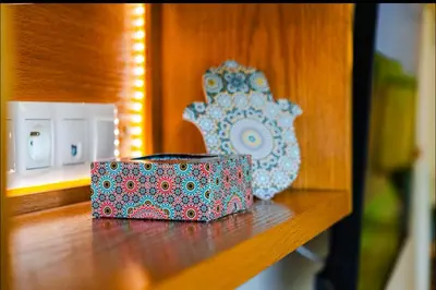 a wooden shelf with a box and a vase on it at Gueliz BEST Residence Nour!! 3 Bedrooms Large Modern Apartment, walking distance to train station and everything in Marrakech