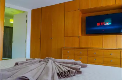 a bedroom with a bed with a tv on a dresser at Gueliz BEST Residence Nour!! 3 Bedrooms Large Modern Apartment, walking distance to train station and everything in Marrakech