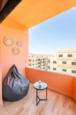 a room with a table and a large window at Spacieux 3 Chambres au Cœur de Marrakech in Marrakech
