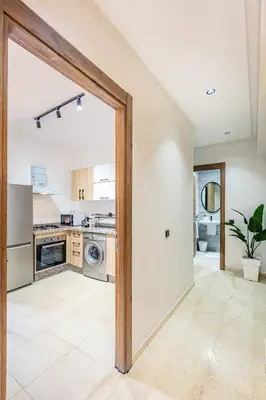 an open door to a kitchen in a house at Spacieux 3 Chambres au Cœur de Marrakech in Marrakech
