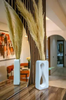 two white vases on a table with a mirror at Spacieux 3 Chambres au Cœur de Marrakech in Marrakech