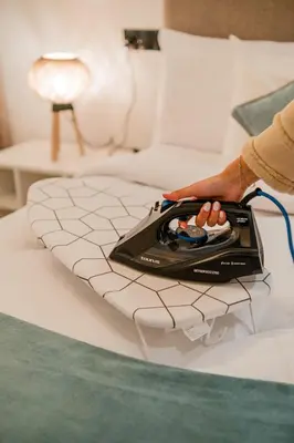 a person sitting on a bed with a tray of food at Chill Repeat Designer 2BR 2BA In Central Gueliz in Marrakech