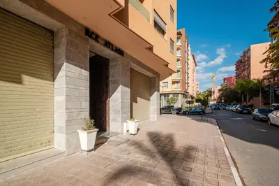 a building with two potted plants on a sidewalk at Chill Repeat Designer 2BR 2BA In Central Gueliz in Marrakech