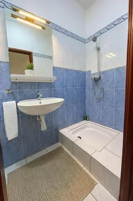 a bathroom with a sink and a bath tub at Riad Mounad with pool - close to Jemaa el-fna in Marrakech