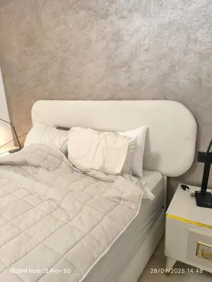 a bed with white sheets and pillows in a room at Appartement moderne au cœur de Marrakech in Marrakech