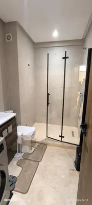 a bathroom with a shower and a toilet and a sink at Appartement moderne au cœur de Marrakech in Marrakech