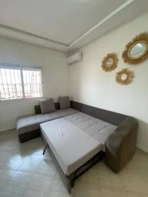 a living room with a couch and mirrors on the wall at Apartment Cosy in Marrakech