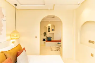 a bedroom with an archway leading into a living room at Central apartment plus jacuzzi in Marrakech