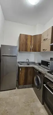 a kitchen with a stainless steel refrigerator and a dishwasher at Appartement moderne à louer Marrakech in Marrakech