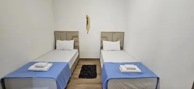 two beds in a room with blue and white at Appartement moderne à louer Marrakech in Marrakech